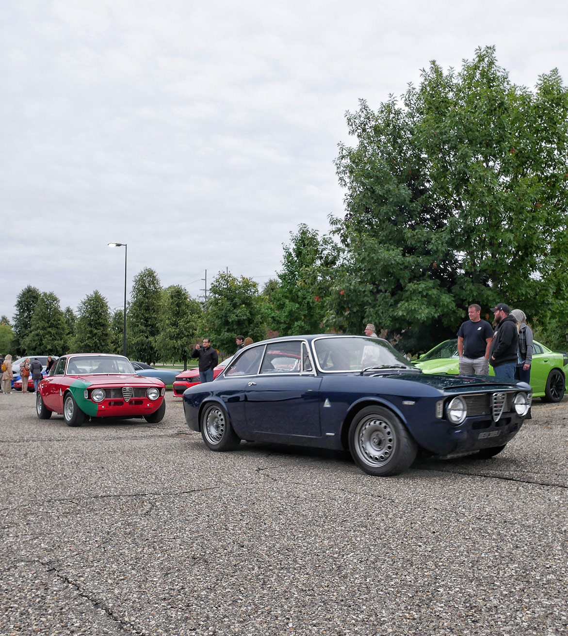 people looking at dodge vehicles on display