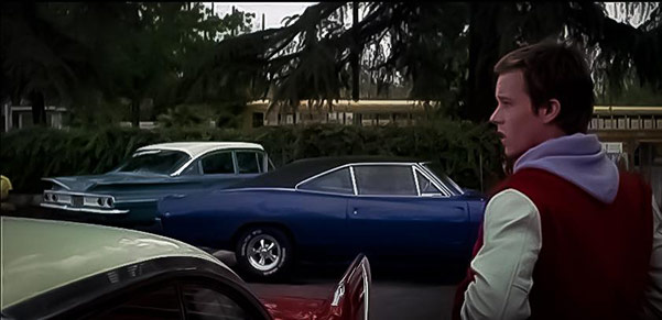 man standing among several vehicles parked outside