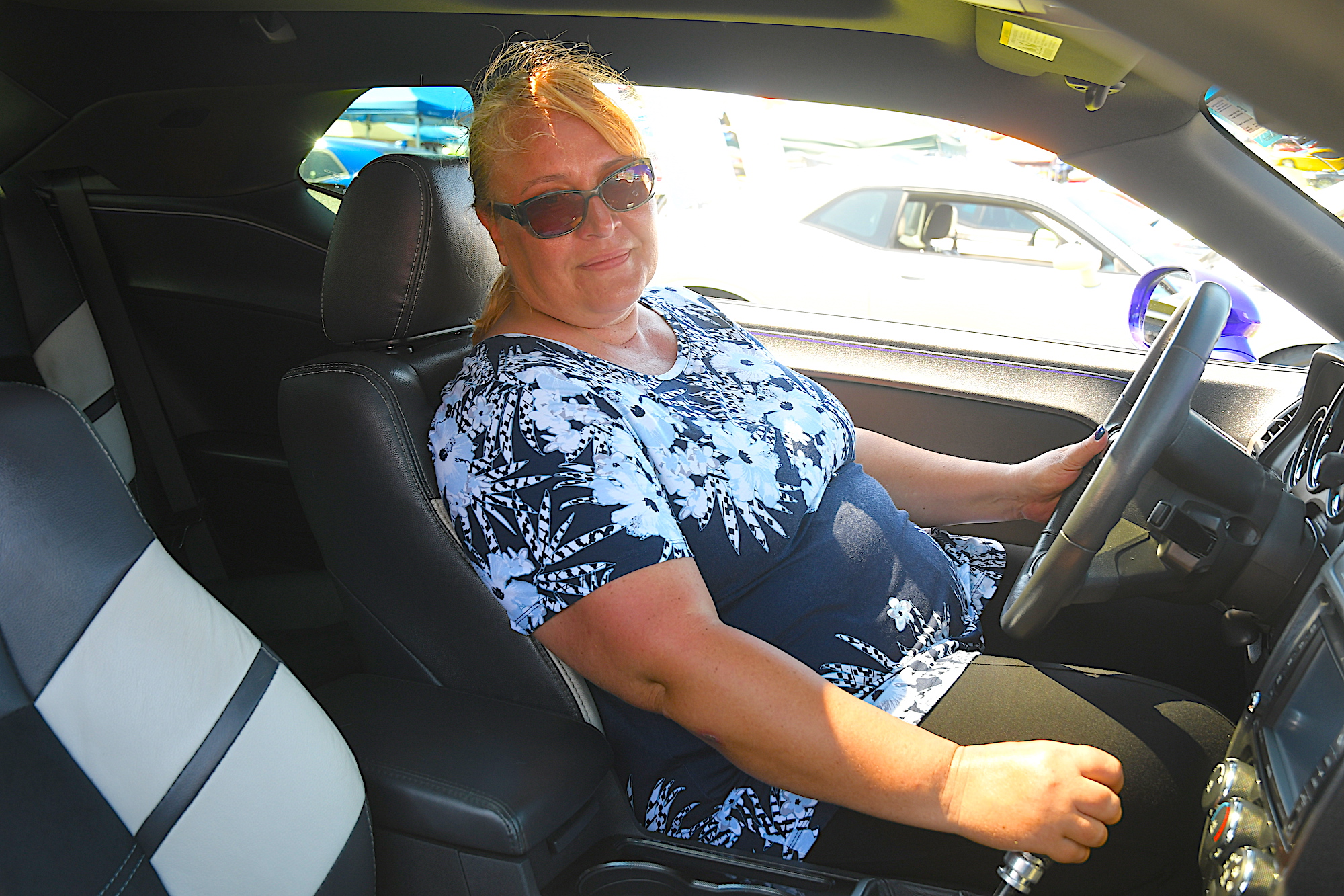 woman sitting inside her dodge vehicle