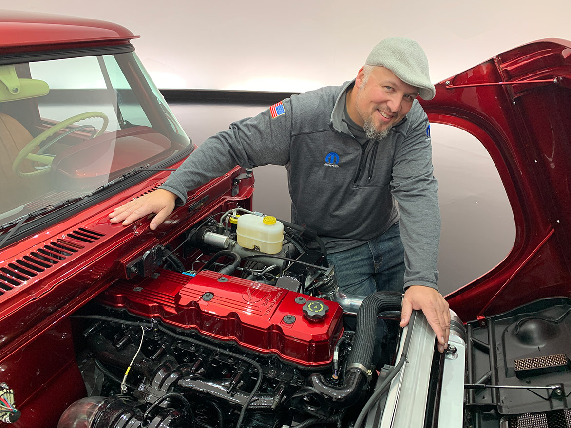 man showing the engine of the Mopar® Dodge Lowliner Concept