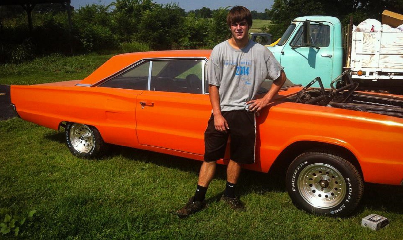 boy standing in front of historic dodge