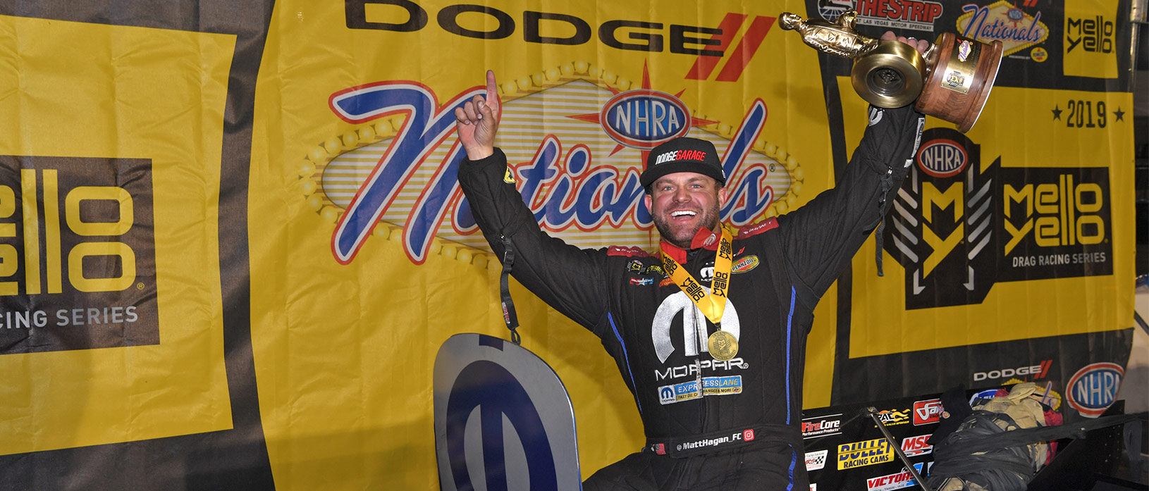 matt hagan holding a wally trophy