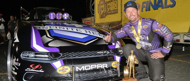 jack beckman with his funny car and wally trophy