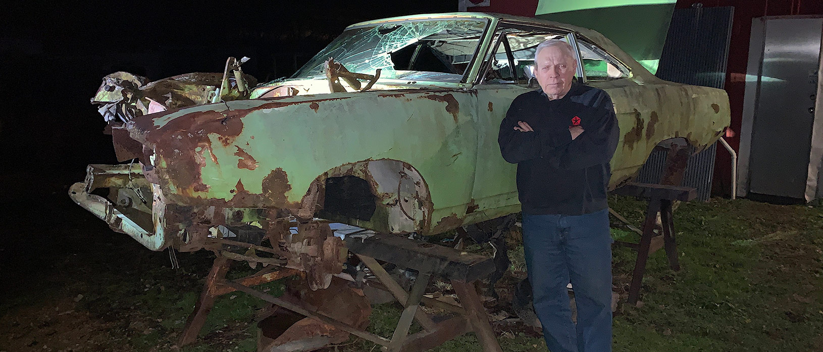 man standing next to old mopar