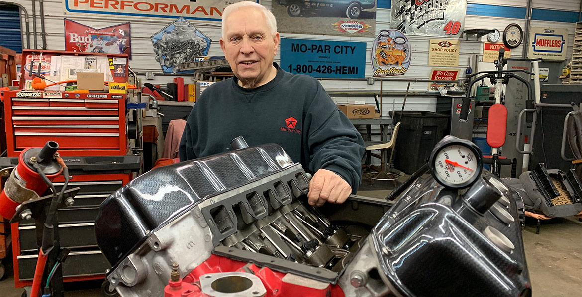 Larry posing with Mopar engine