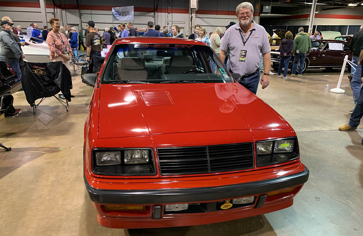 Man standing next to Shelby Lancer