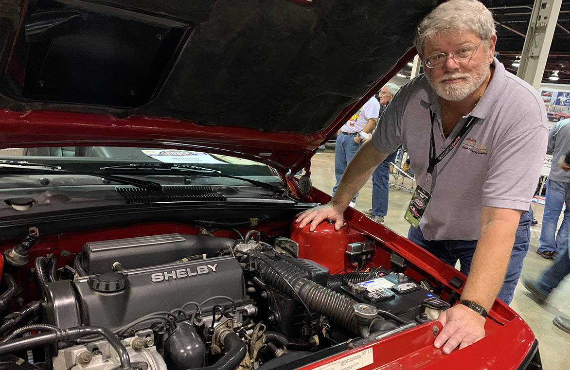 Man standing next to Shelby Lancer