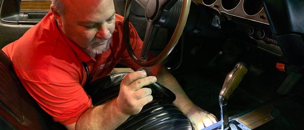 man looking at shifter on historic dodge