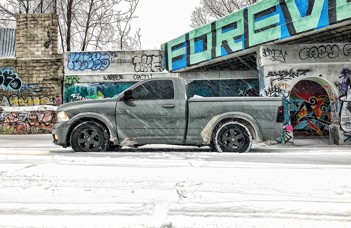 Dodge RAM driving through snow covered road