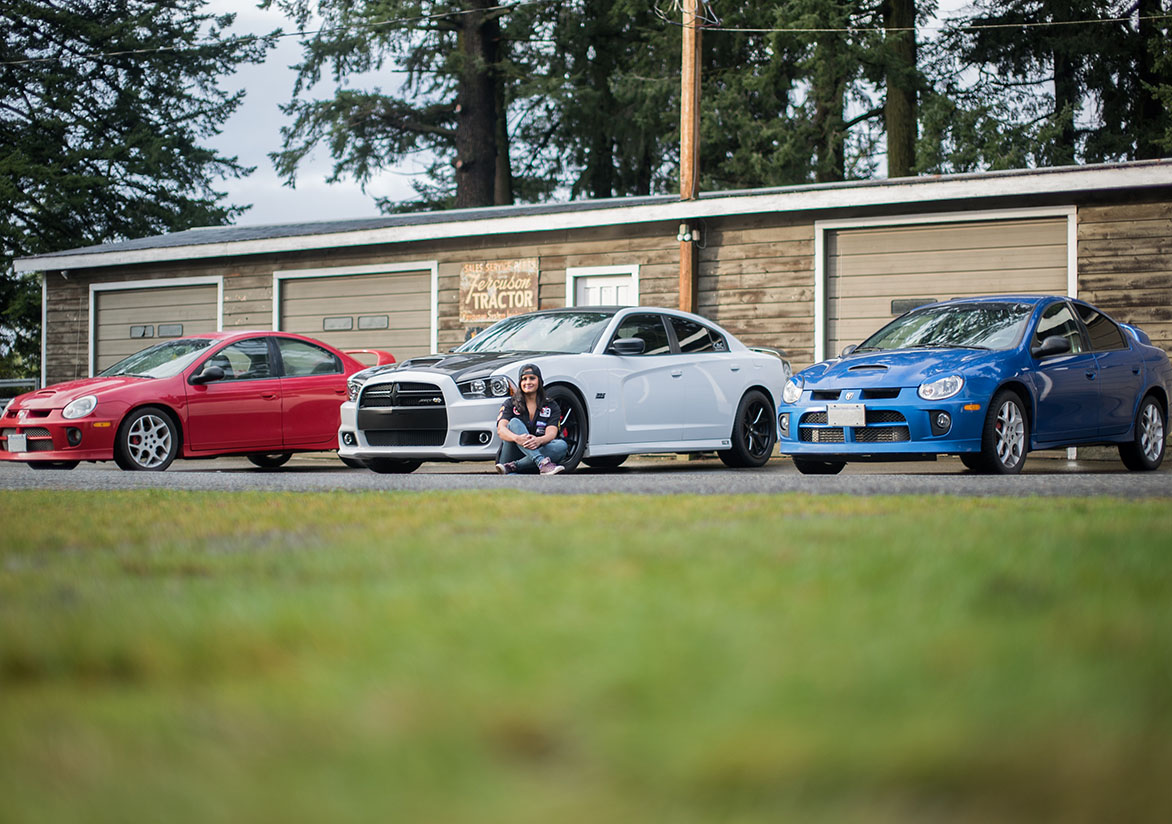 Red Dodge Neon, White Dodge Charger and Blue Dodge Neon with Jovita sitting in front