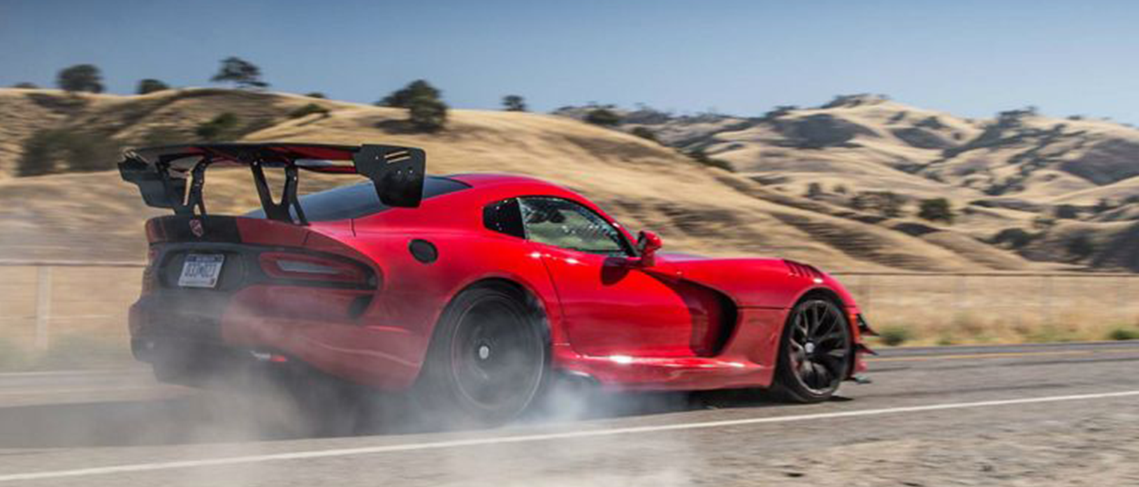 dodge viper driving down a road