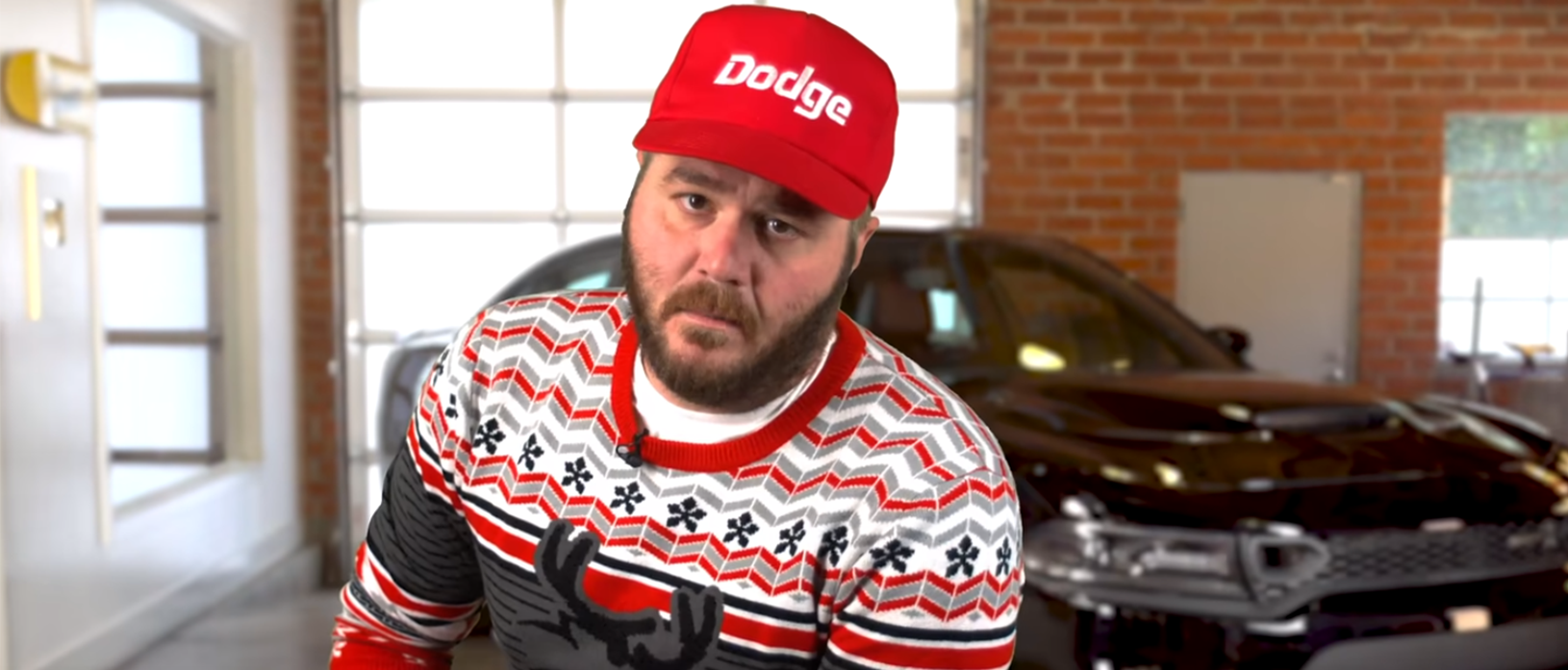 Man in front of a dodge vehicle