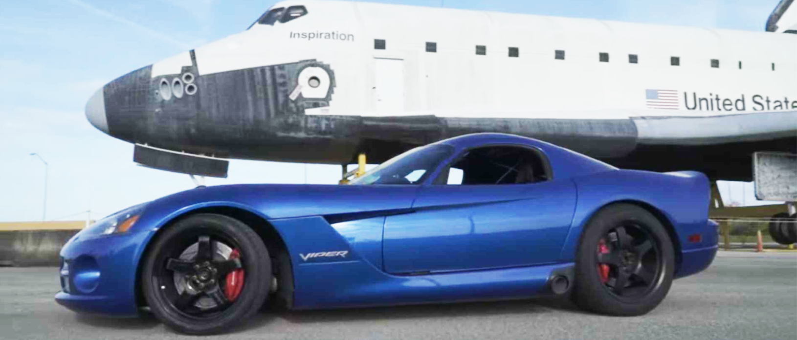 2006 dodge viper next to an airplane