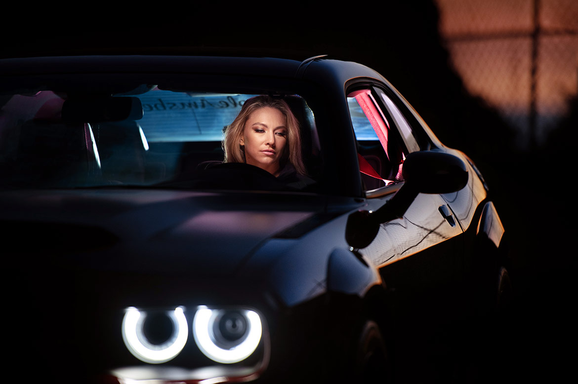 Woman in a dodge challenger