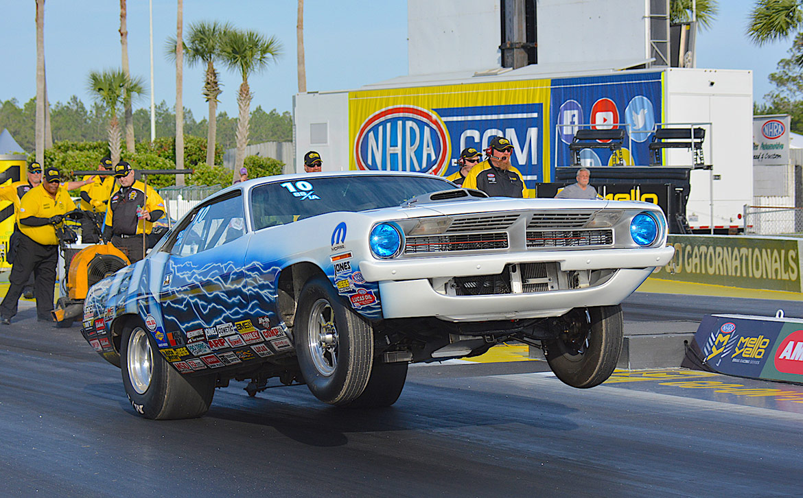 vehicle on two wheels on a drag strip