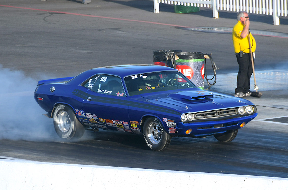 vehicle doing a burnout on the starting line of a drag strip