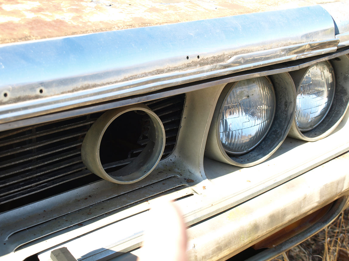 headlights and grill on discarded vehicle