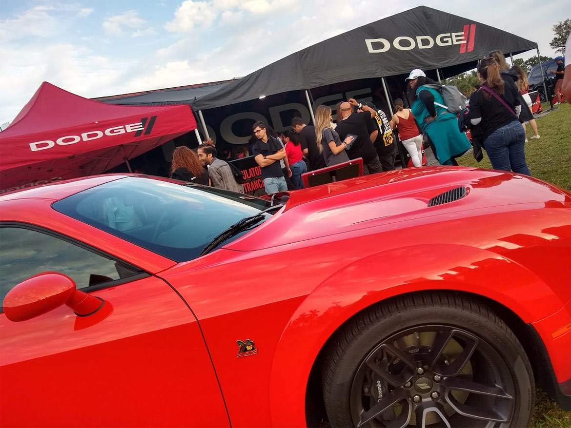 crowd surrounding a dodge display