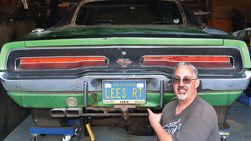 man pointing at his vehicle's license plate