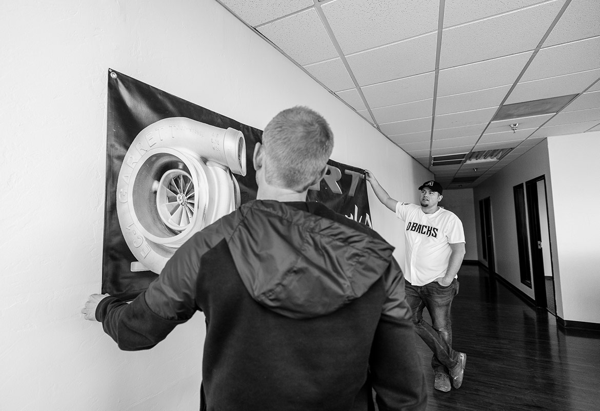 men hanging a banner