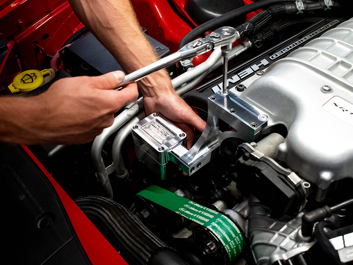 man working on a vehicle engine