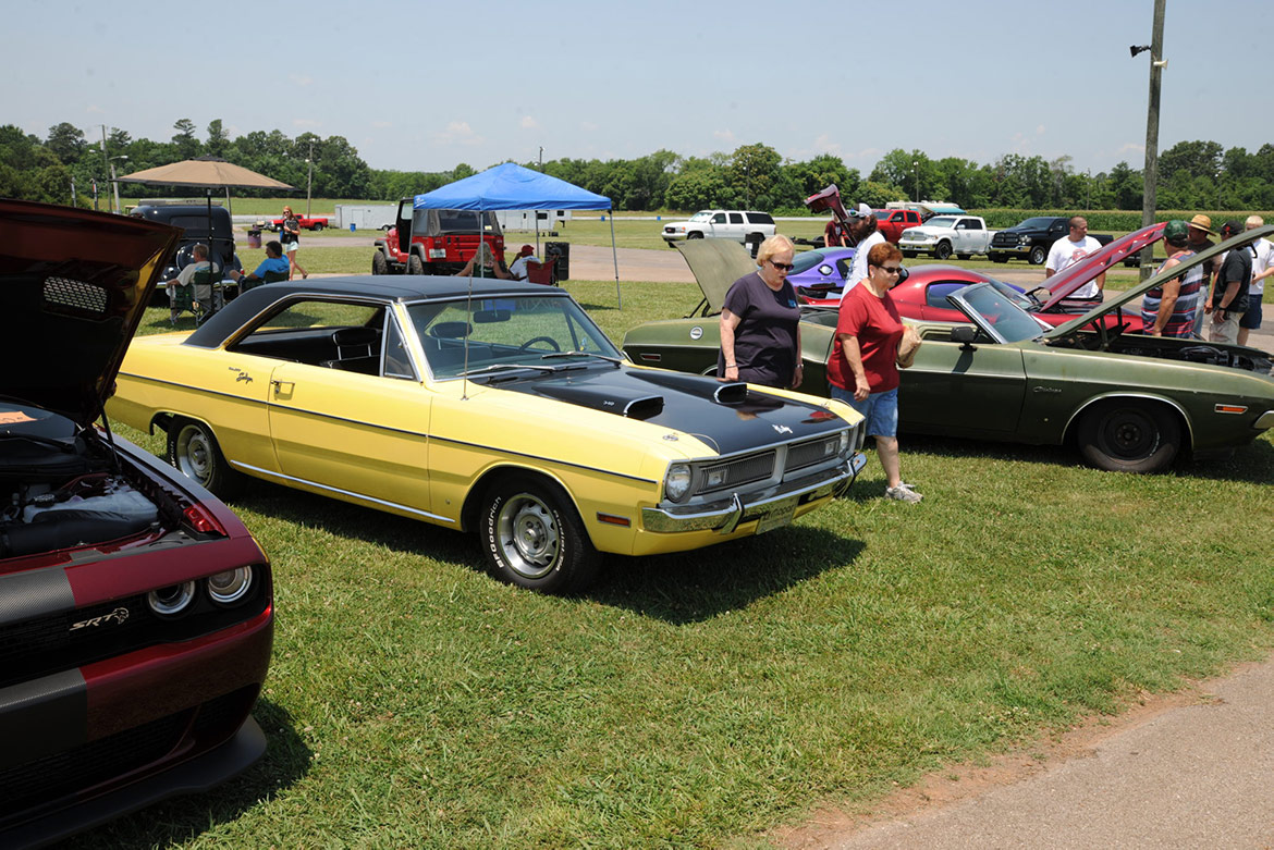 people viewing vehicles on display