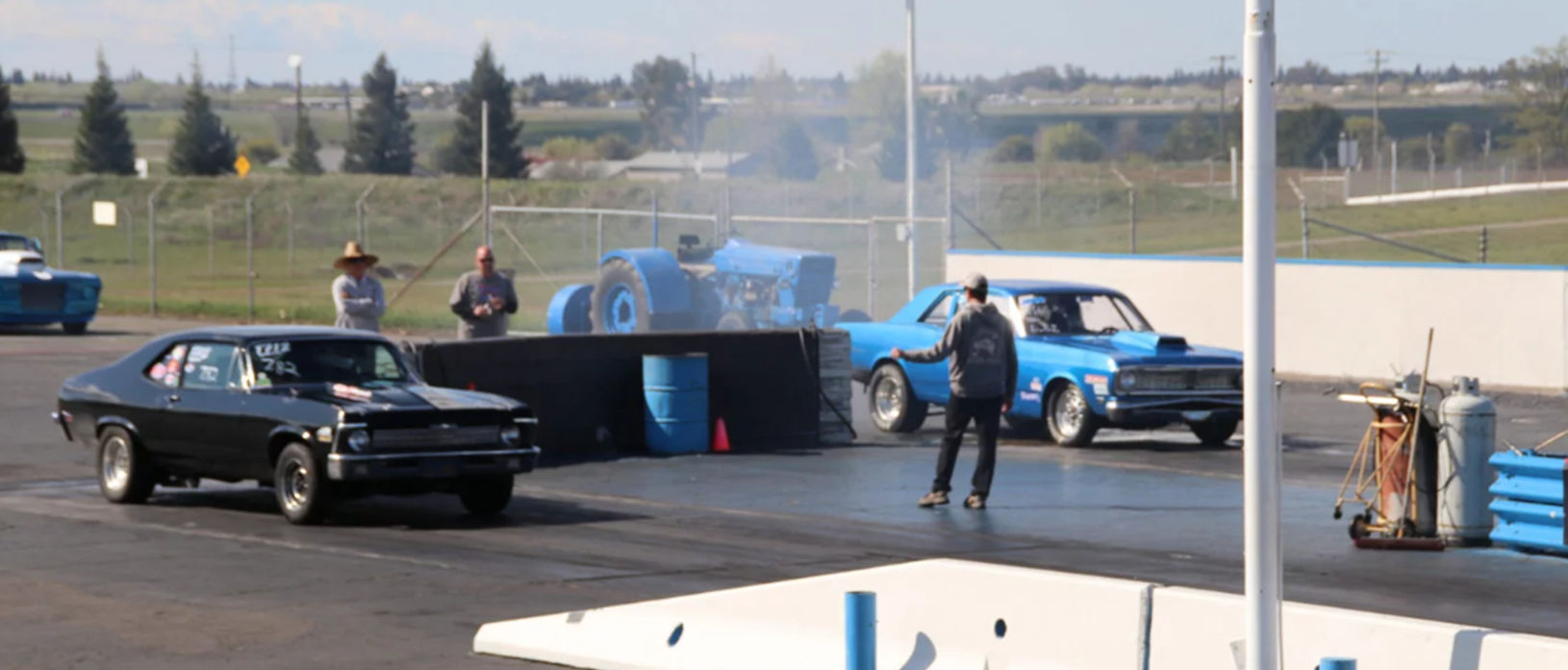 cars on the starting line of a drag strip