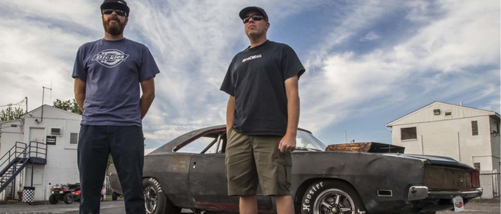 David Freiburger and Michael Finnegan standing with a car