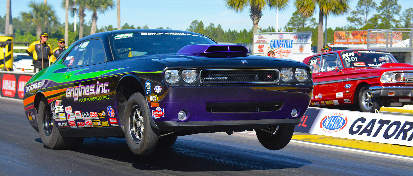 dodge challenger on the starting line of a drag strip