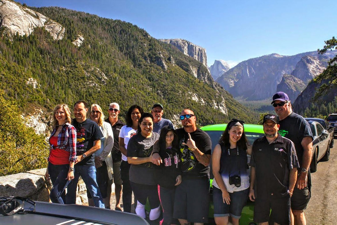 group of people on a nature trail with their vehicles