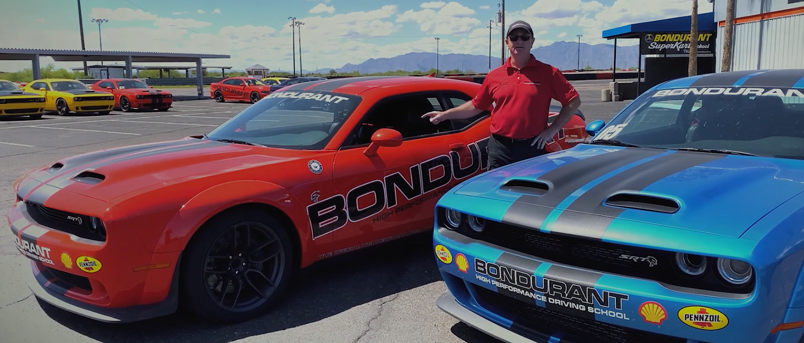 man with two dodge vehicles