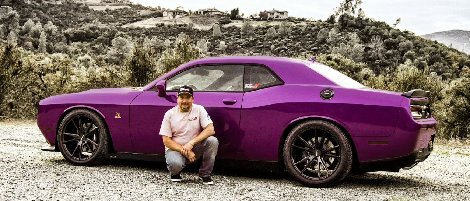 Man kneeling in front of his Challenger