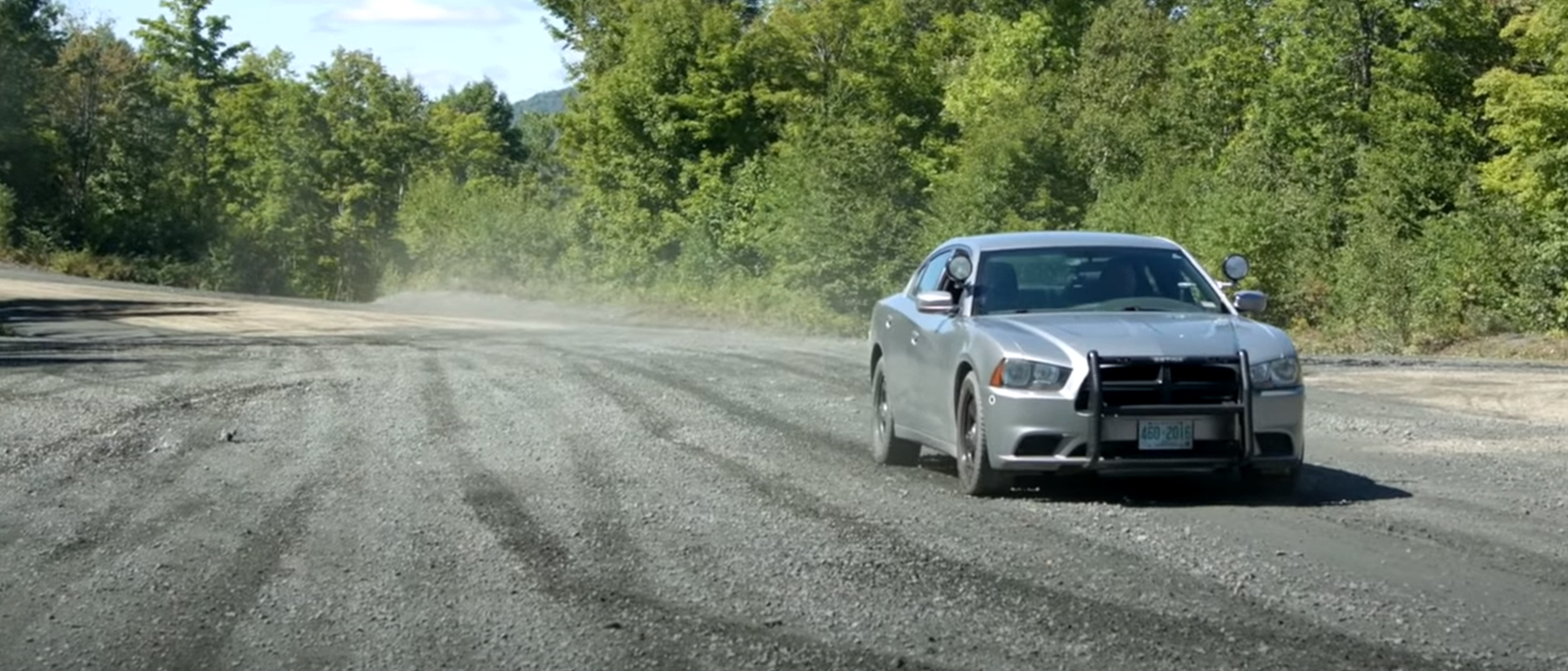 2013 dodge charger police pursuit on a gravel road