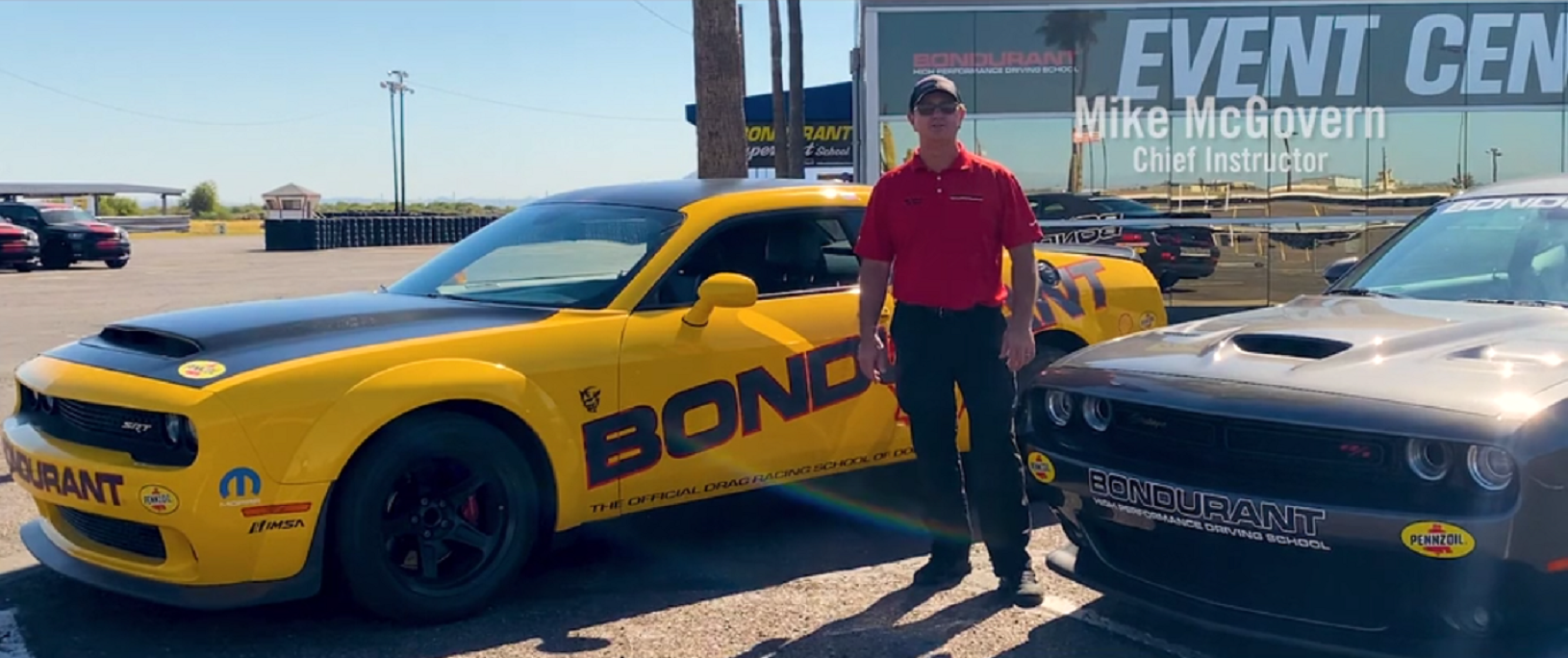 Mike McGovern standing in between a SRT Demon and a 1320