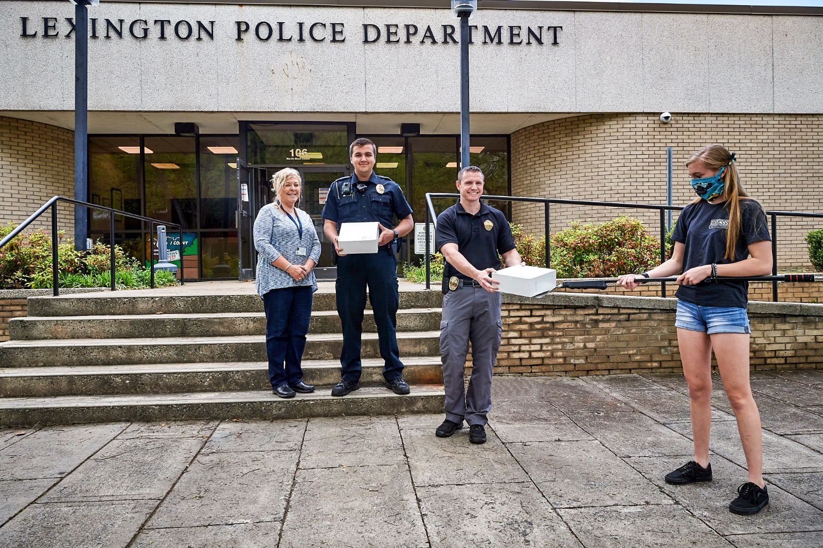 Gray Ledbetter delivering donuts to Lexington Police Department