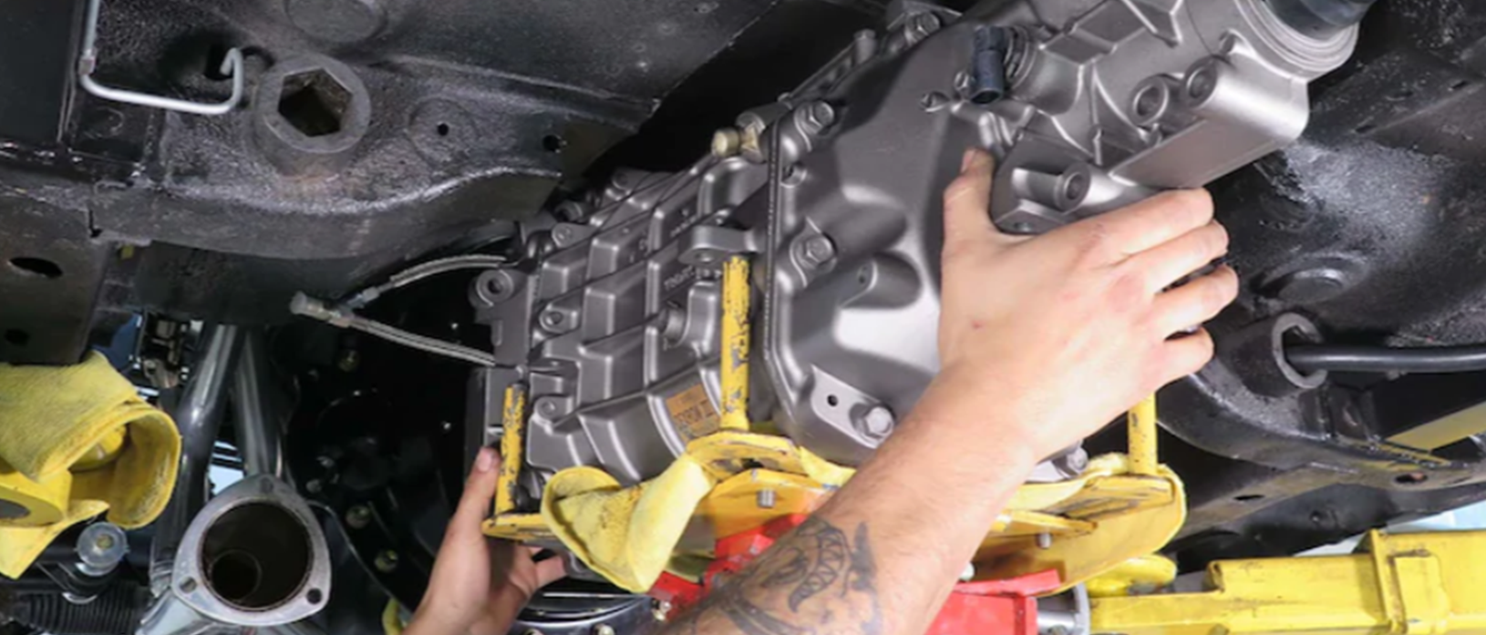 man working on a vehicle engine