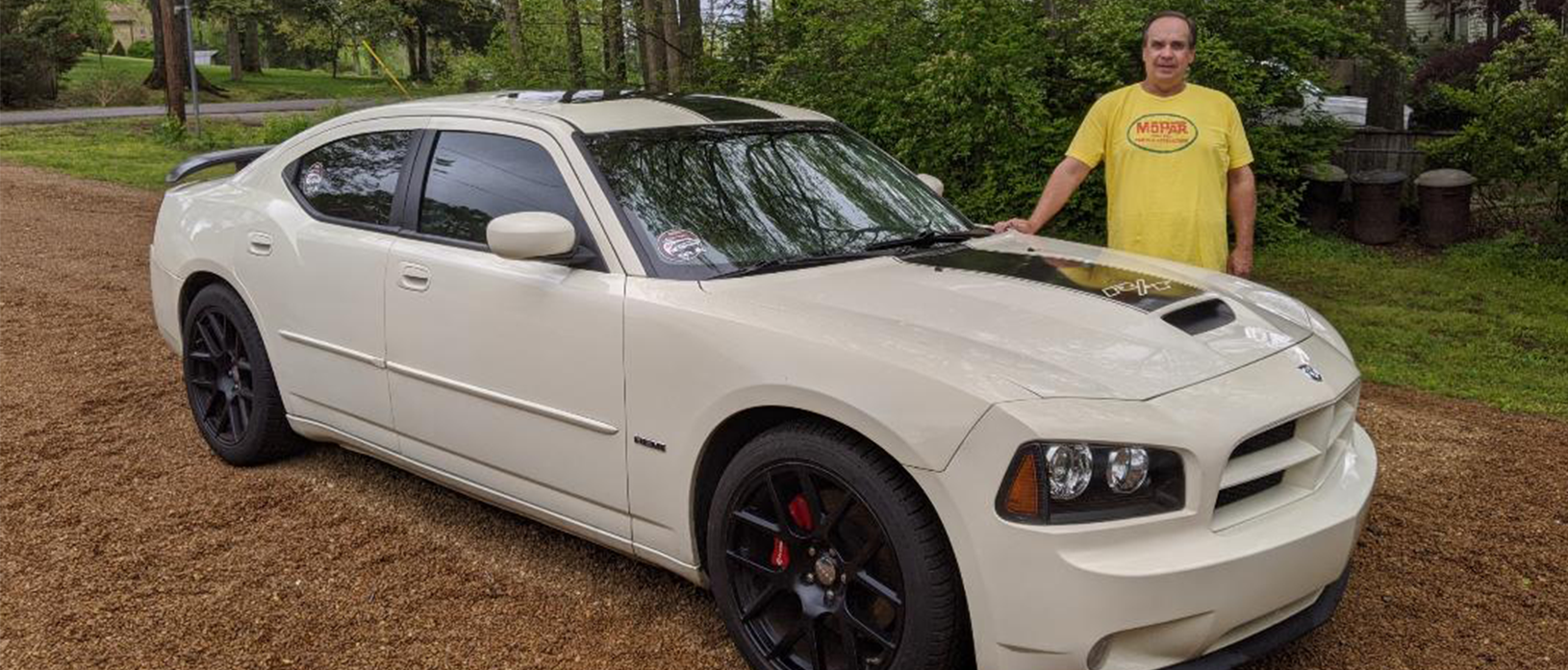 man standing with a 2006 Dodge Charger R/T