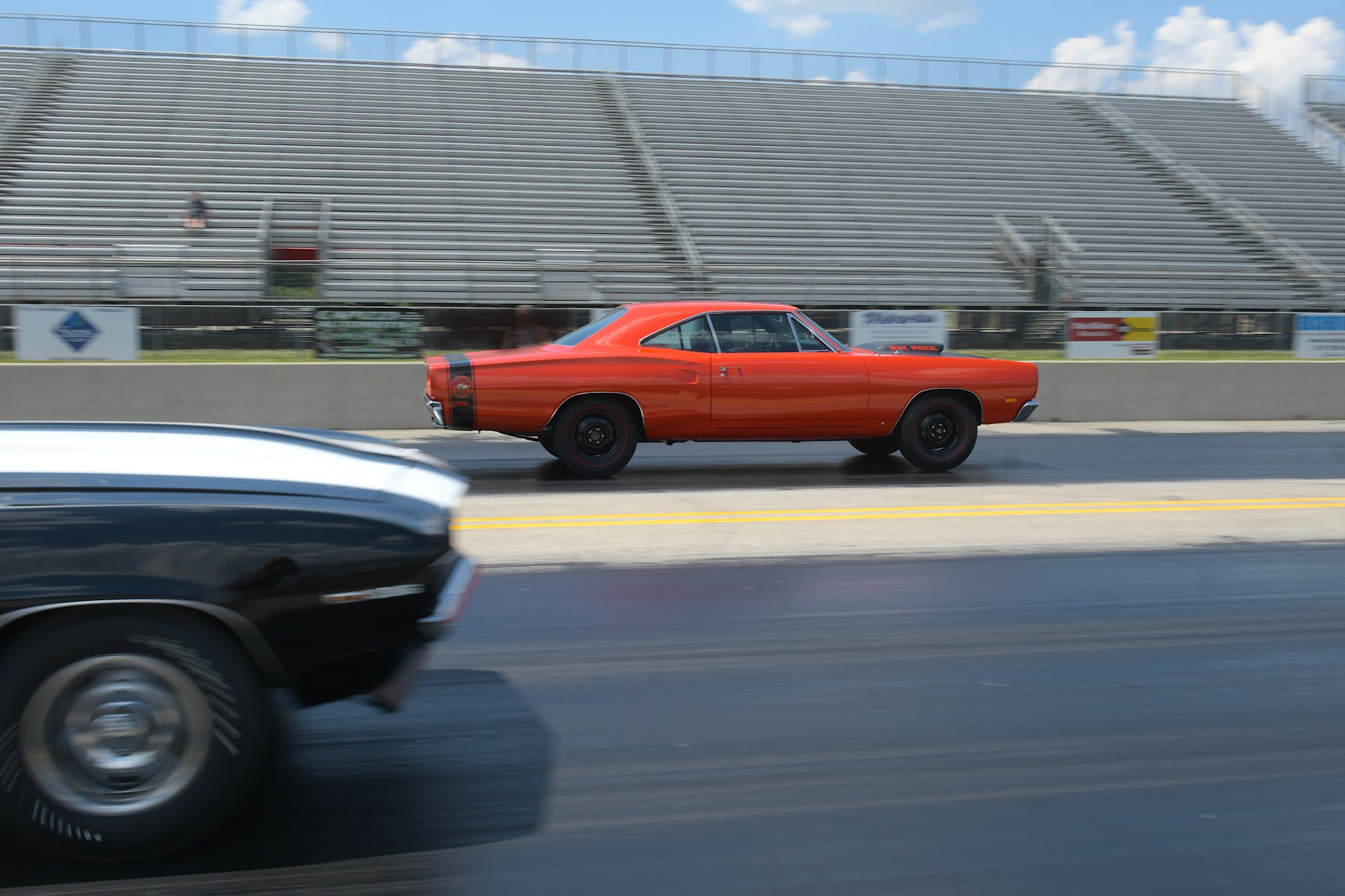 two vehicles racing on a drag strip