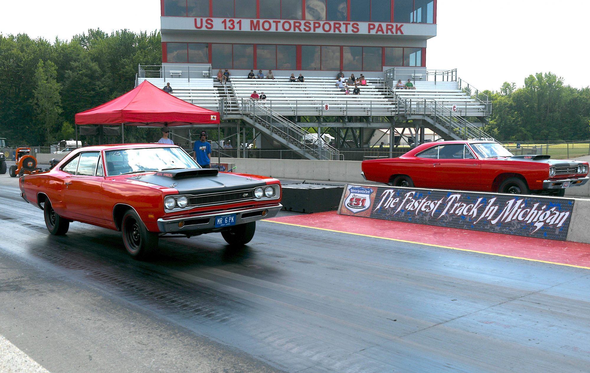 two vehicles racing on a drag strip