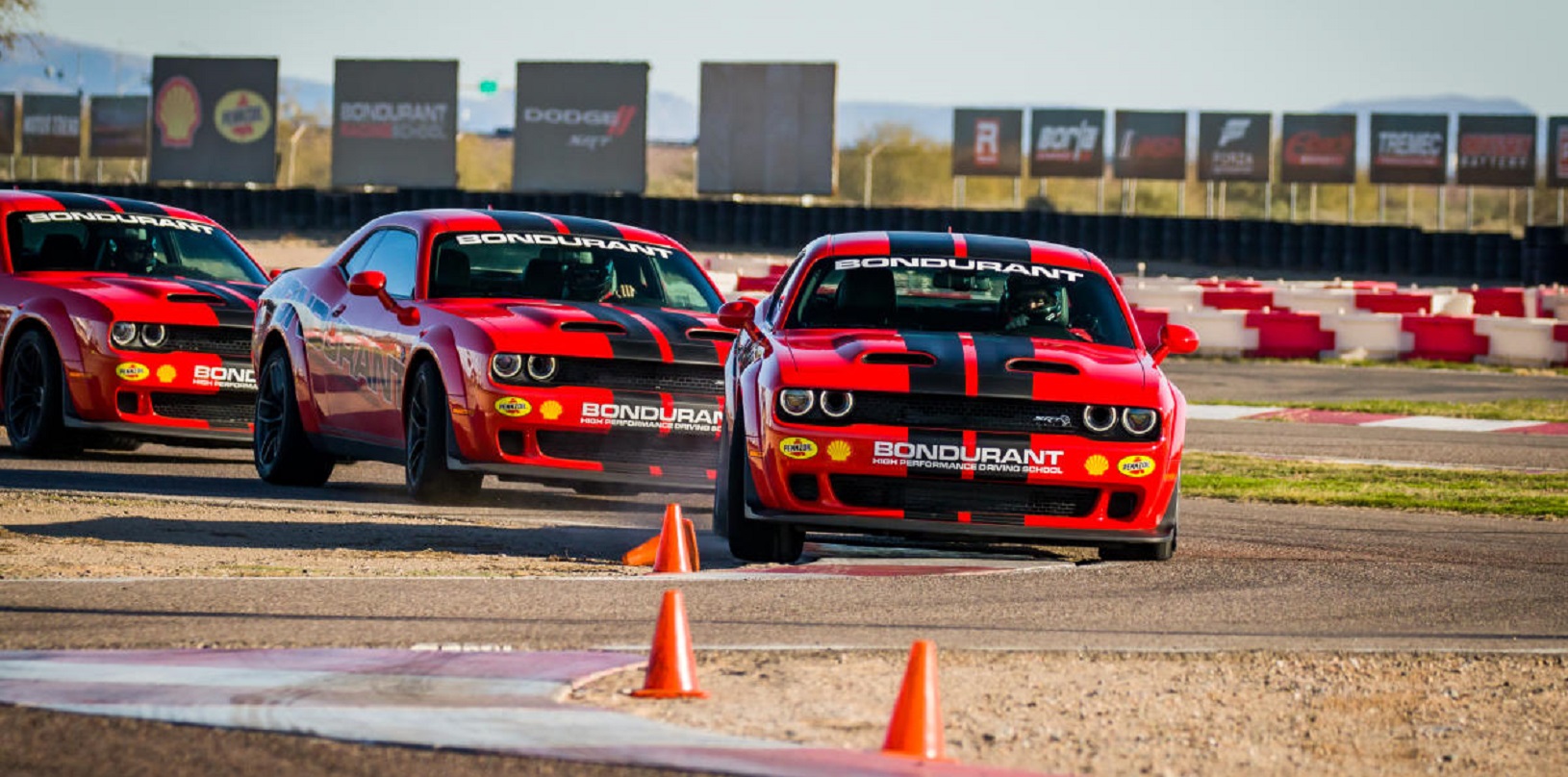 Chargers and Challengers driving on Bondurant track