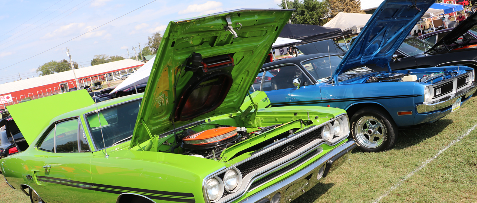 Row of Mopar vehicles at a car show