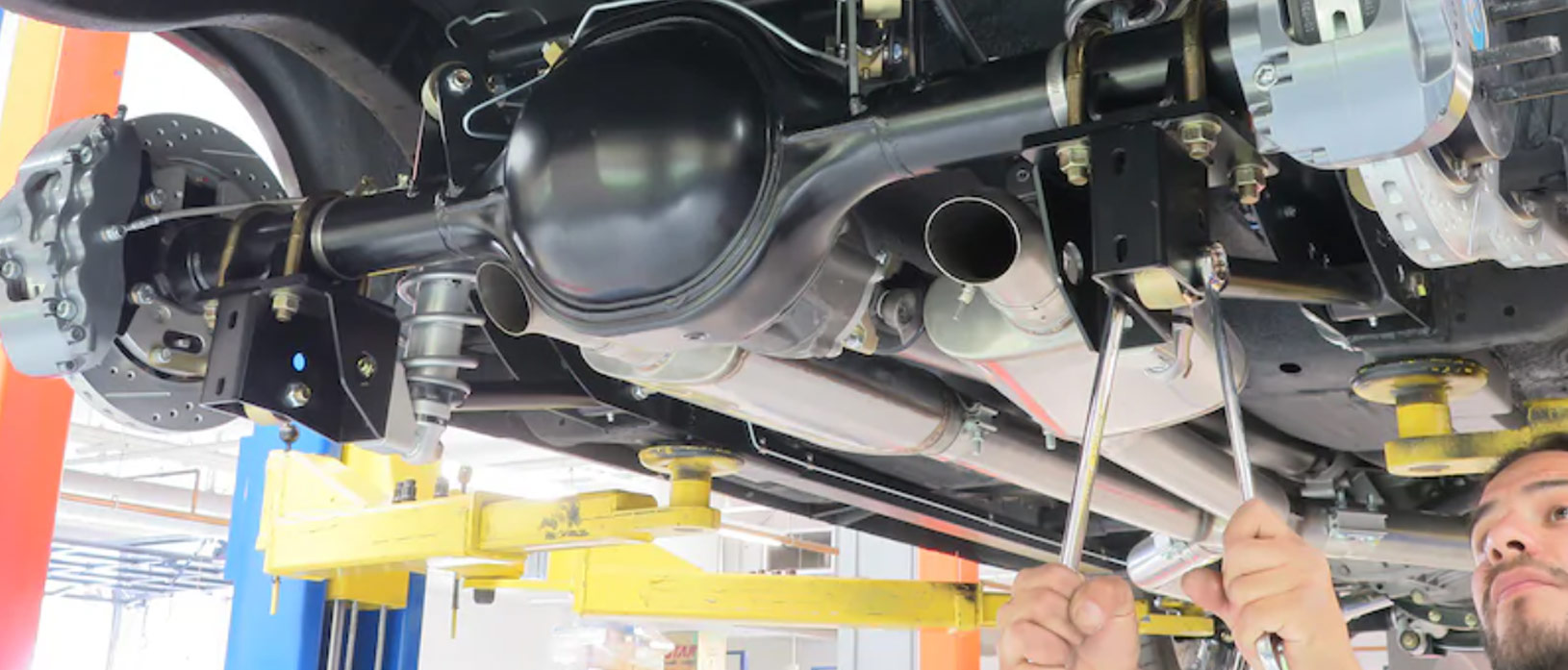 man working on a vehicle engine