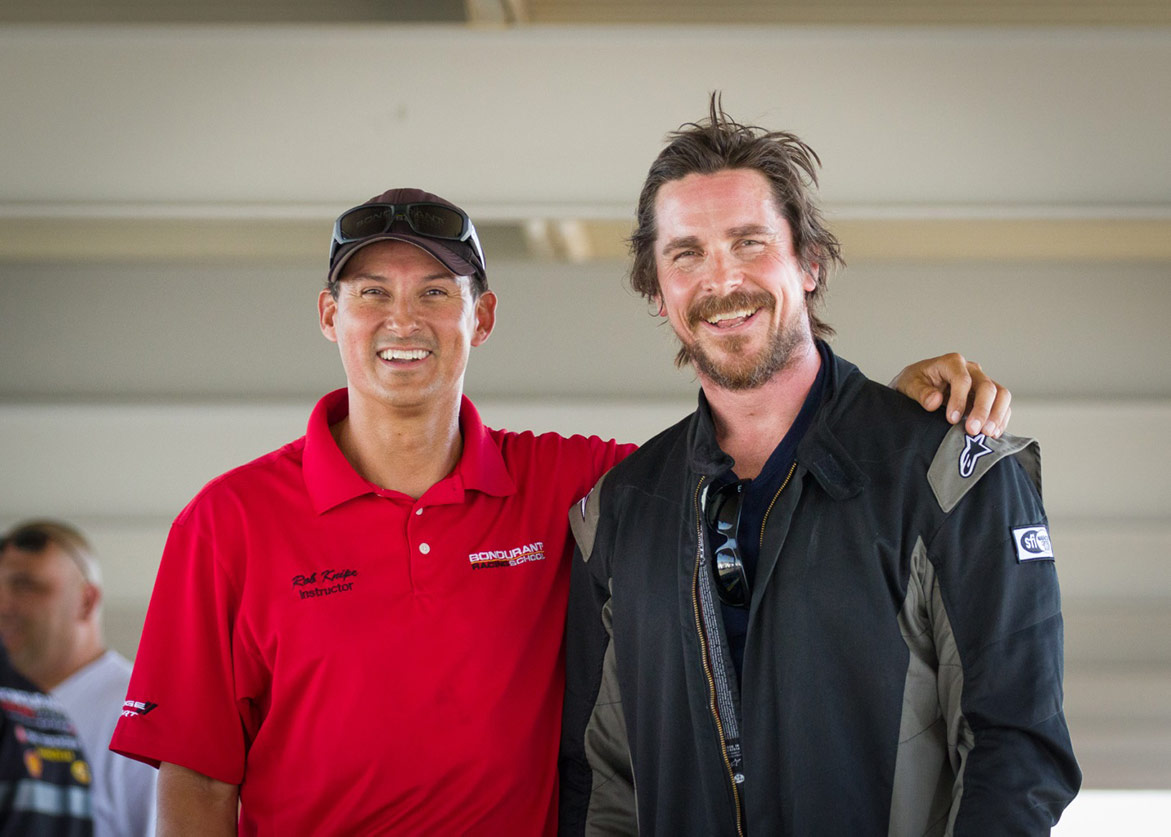 man standing with Christian Bale