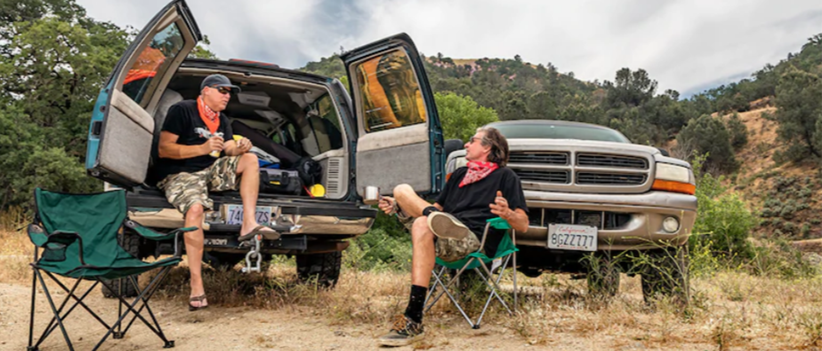 David Freiburger and Steve Dulcich sittng outside with their vehicles