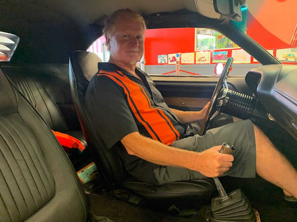 owner sitting in the driver's seat of his vehicle