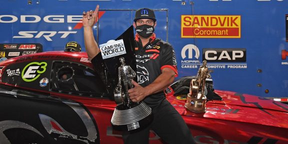 Matt Hagan holding his trophy