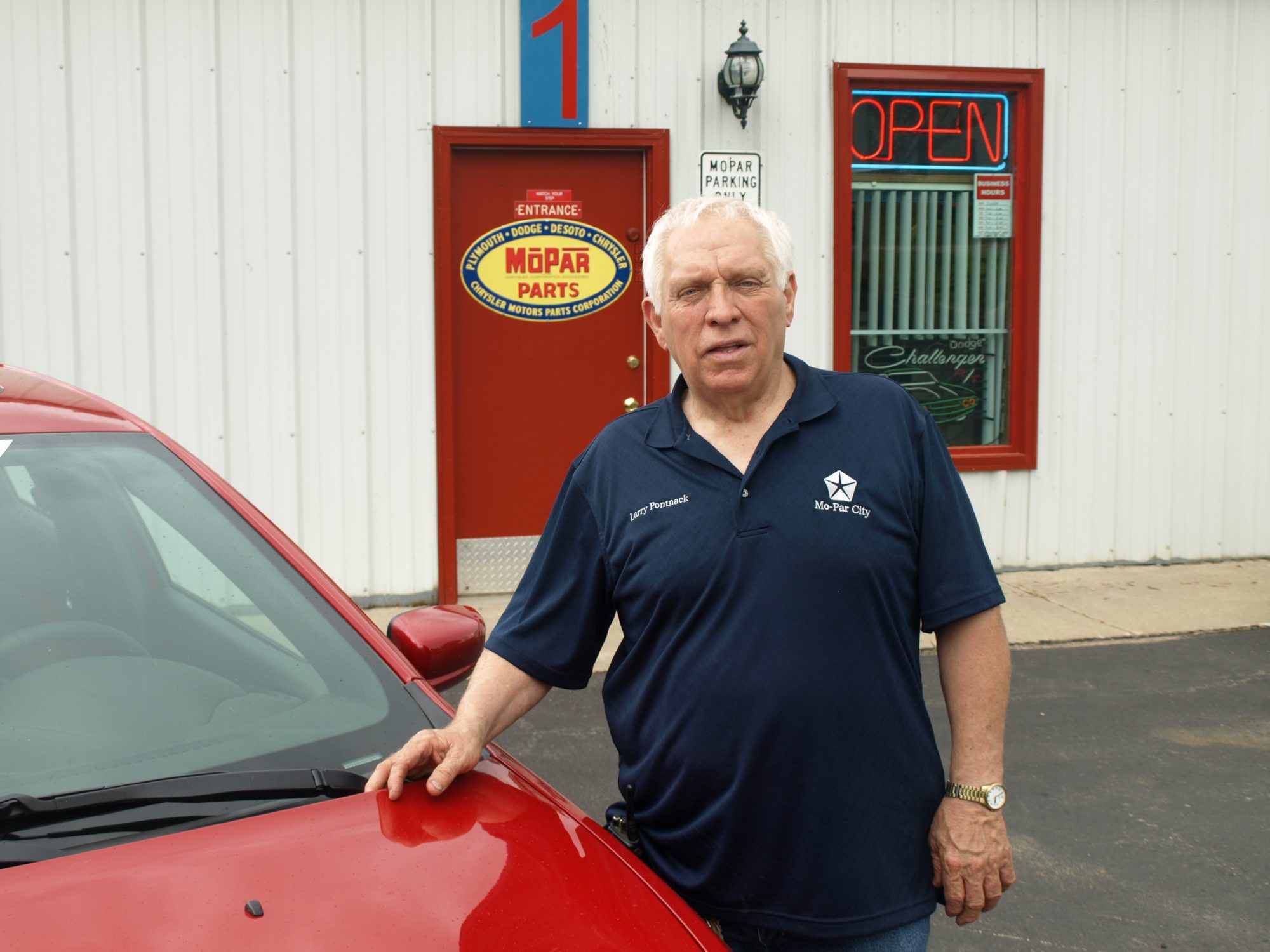 Larry Pontnack standing outside of his Mopar business