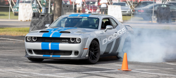 Dodge vehicle drifting around a cone