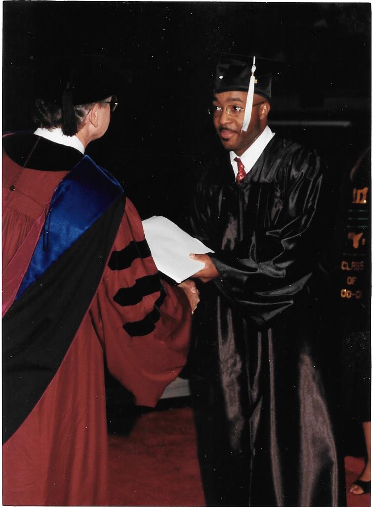 Anthony Carter receiving his degree