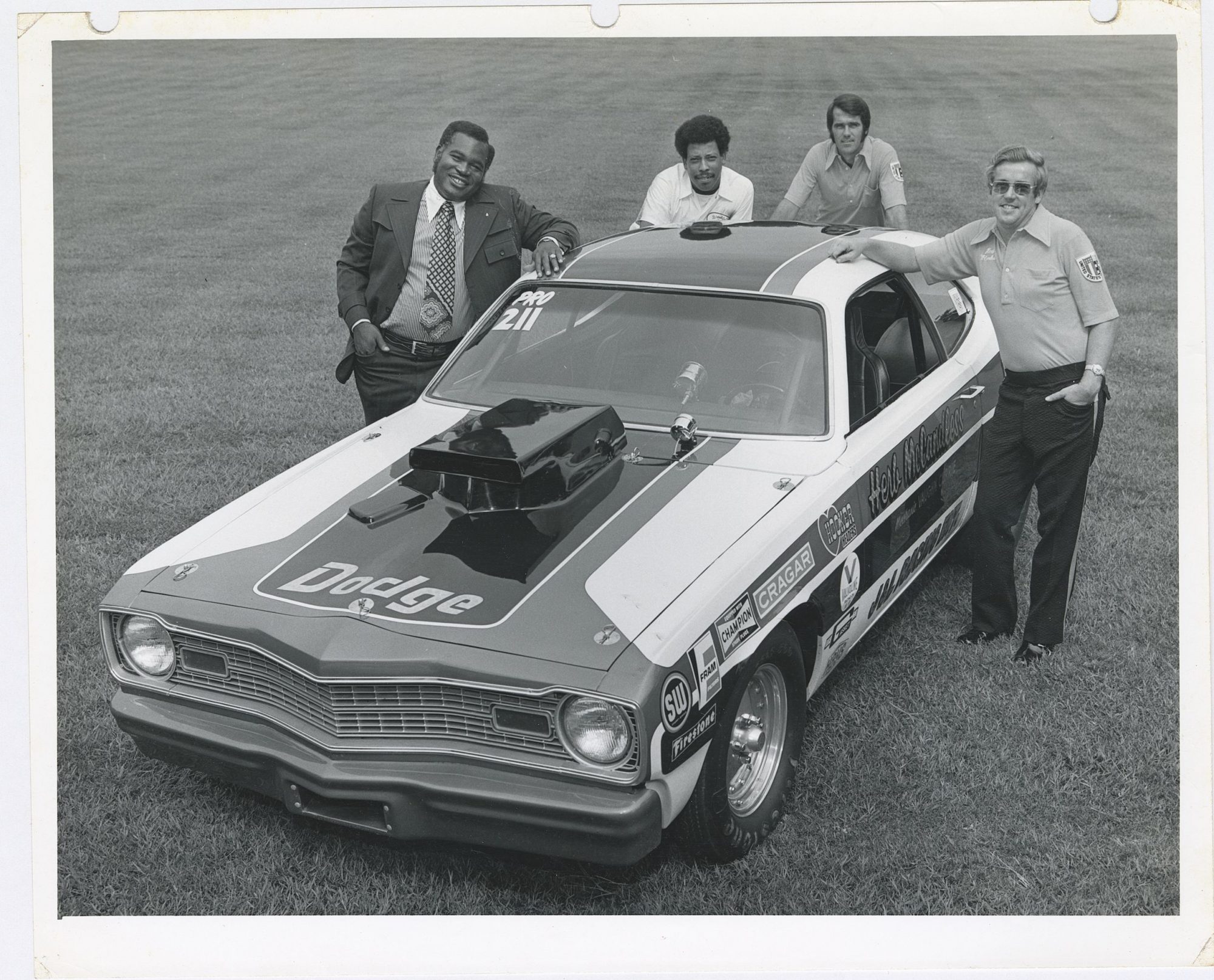 Herb McCandless posing next to his race car